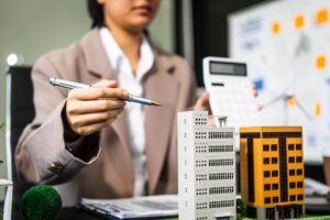 A young businesswoman is working at her desk, managing legal matters related to real estate